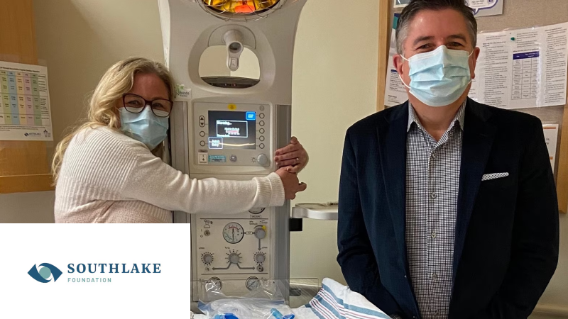 A doctor and patient wearting masks are shown in a hospital room. 