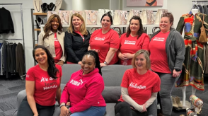 A group of Honda employees pose for a picture in red Honda shirts. 