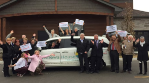 A group of people from Honda and the Matthews Hopuse Hospice pose for a picture in front of a Honda Odyssey. 